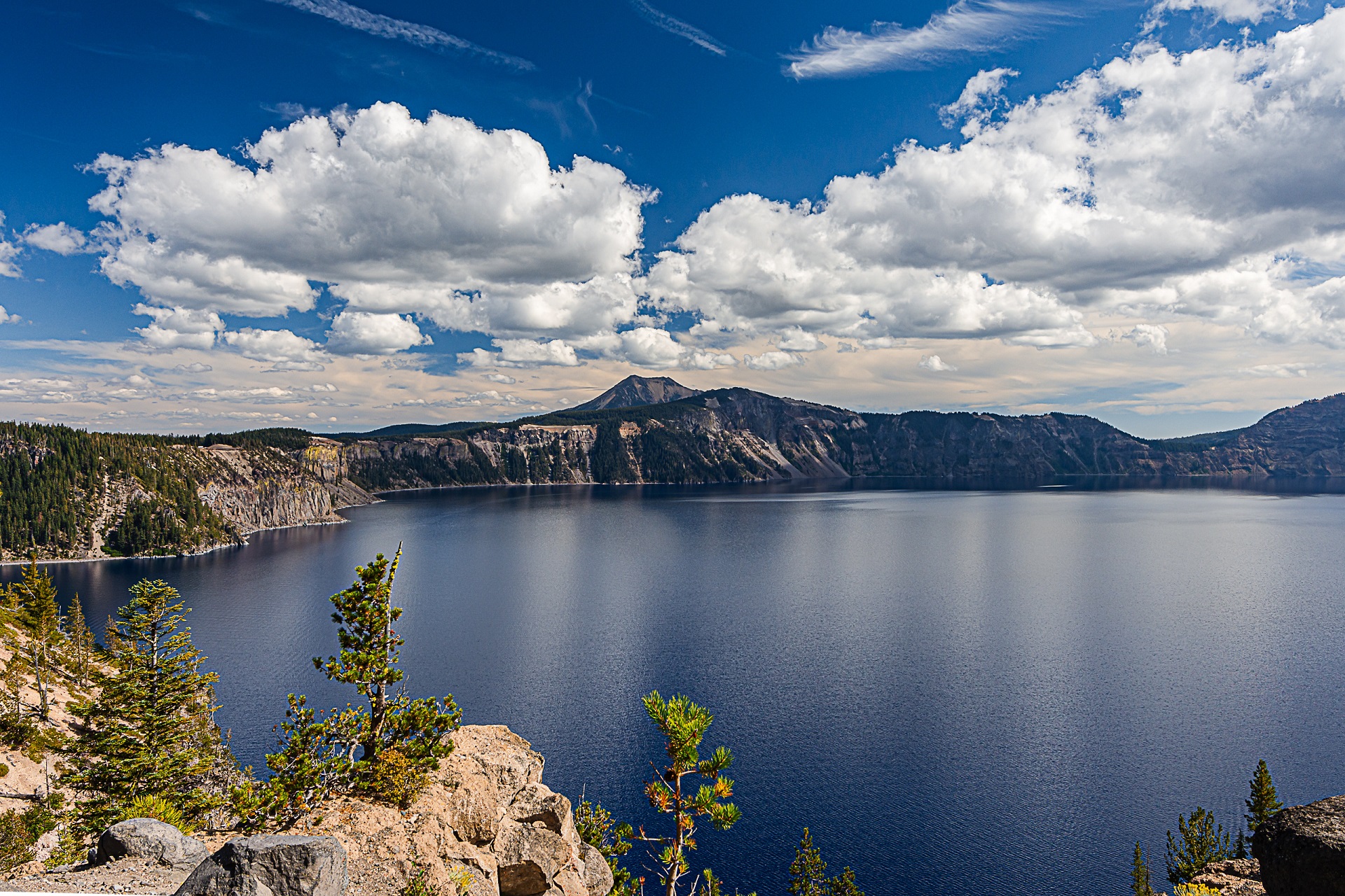 Crater Lake with Wizard Island and dramatic summer clouds, Oregon landscape photography by Tammy Jaquith.
