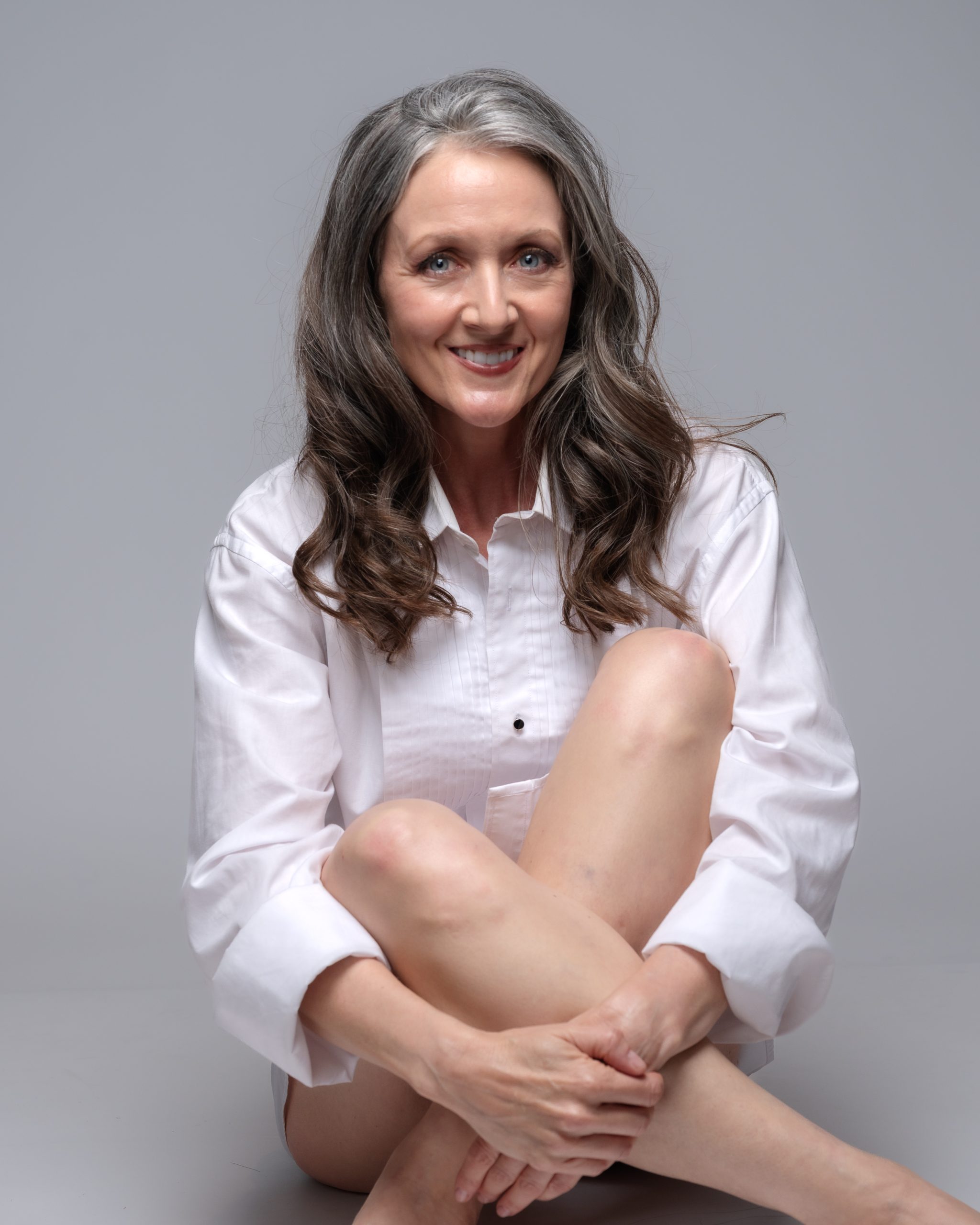 Women's portrait in a white shirt with natural silver hair, relaxed and confident, fine art photography by Tammy Jaquith in Oregon.
